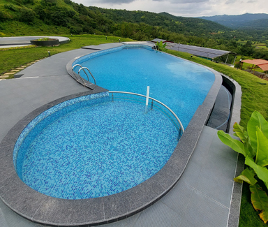 Infinity Swimming Pool with Jacuzzi and Kids pool area at Anantsrushti Agrotourism